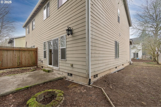 view of property exterior with a fire pit and a patio area