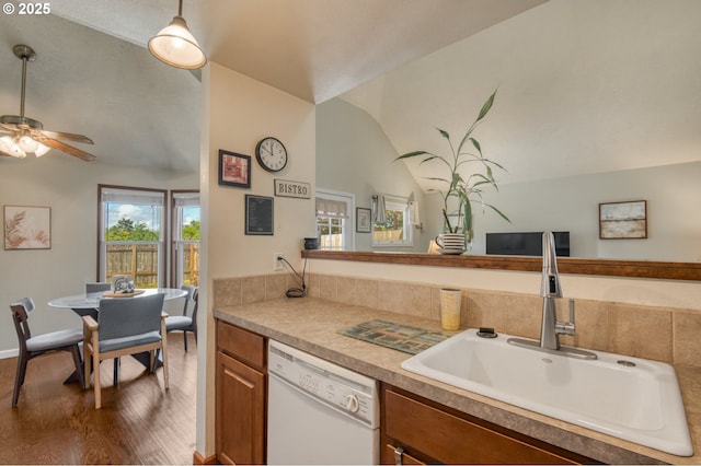 2251 SW Trachsel Dr, Beaverton, OR 97003 - kitchen with dishwasher, a sink, wood finished floors, brown cabinetry, and lofted ceiling
