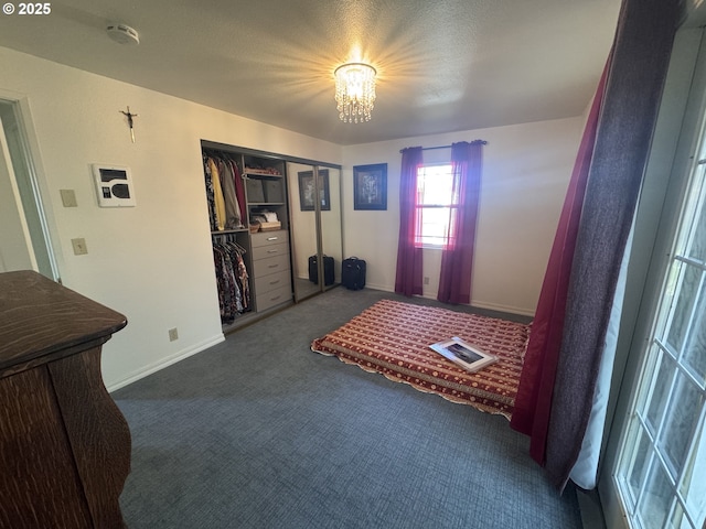 foyer entrance with baseboards, carpet flooring, and a notable chandelier