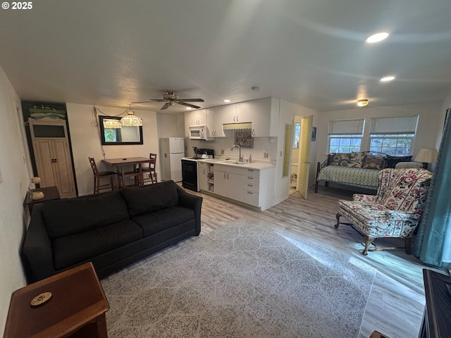 living area featuring recessed lighting, a ceiling fan, and light wood-style flooring
