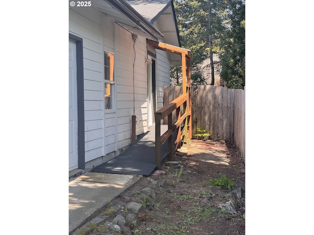 view of side of home with fence
