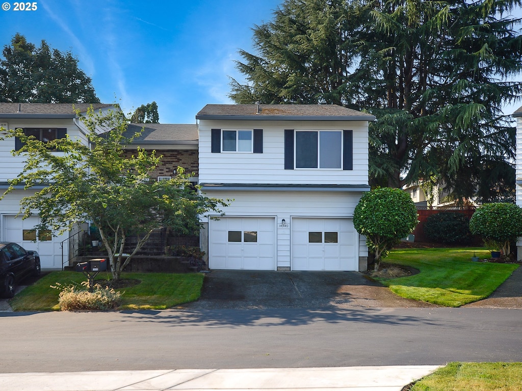 view of front of home with a garage and a front lawn