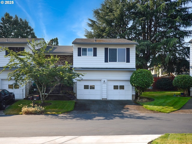 view of front of home with a garage and a front lawn