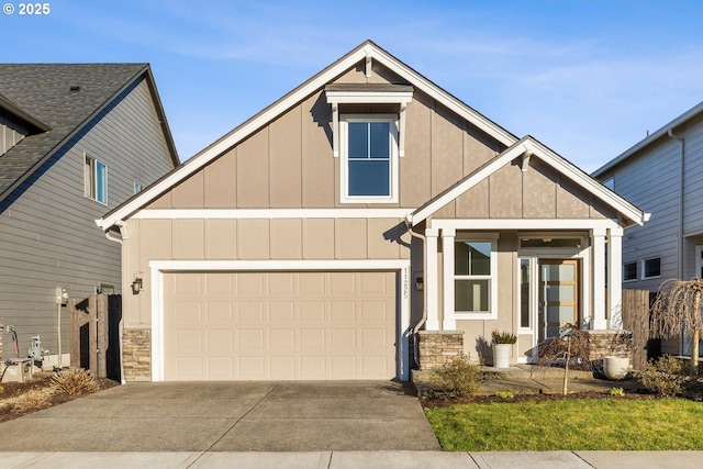 view of front of property featuring board and batten siding, concrete driveway, and stone siding