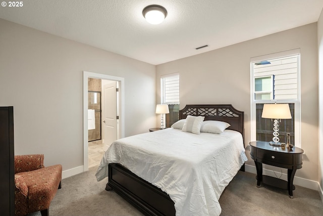 carpeted bedroom featuring a textured ceiling, visible vents, and baseboards