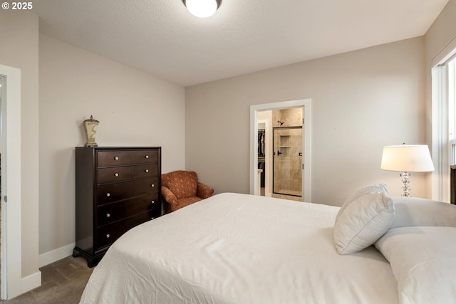 bedroom featuring carpet floors, a textured ceiling, and baseboards