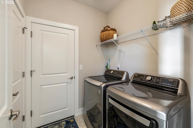 clothes washing area with washer and dryer and laundry area