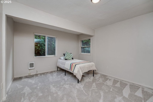 carpeted bedroom featuring a textured ceiling