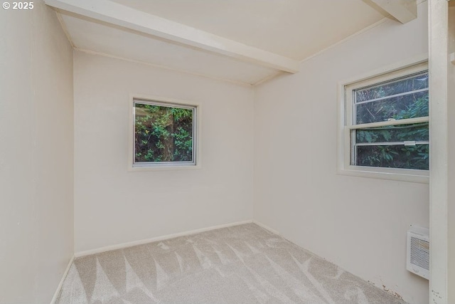 unfurnished room featuring light carpet and beam ceiling