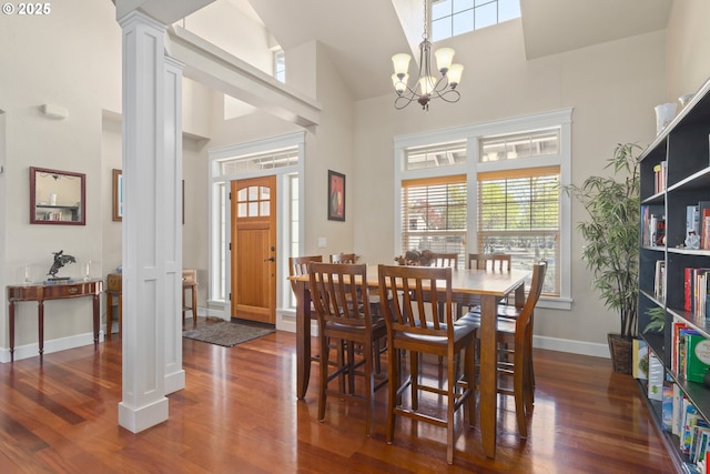 2610 Crowther Dr, Eugene, OR 97404 - dining space with high vaulted ceiling, ornate columns, wood finished floors, a chandelier, and baseboards