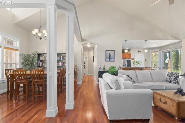 2610 Crowther Dr, Eugene, OR 97404 - living area featuring high vaulted ceiling, wood finished floors, arched walkways, baseboards, and a chandelier