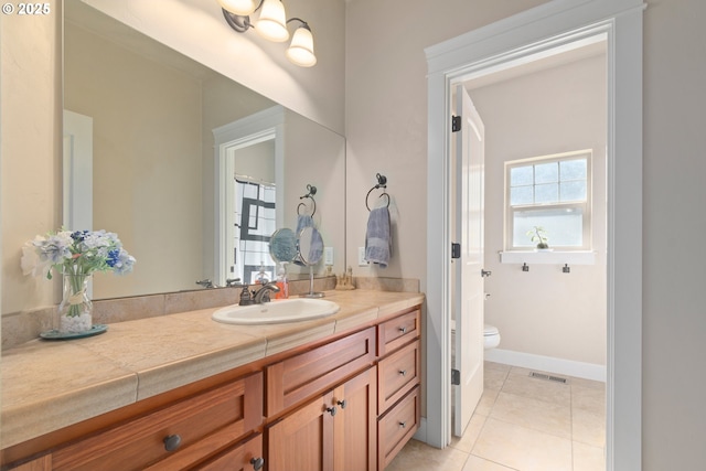 2610 Crowther Dr, Eugene, OR 97404 - full bathroom with vanity, toilet, tile patterned flooring, and baseboards