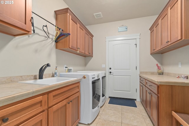 2610 Crowther Dr, Eugene, OR 97404 - washroom featuring cabinet space, independent washer and dryer, and light tile patterned floors