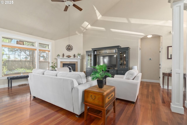 2610 Crowther Dr, Eugene, OR 97404 - living area featuring arched walkways, ceiling fan, dark wood-type flooring, a tile fireplace, and baseboards
