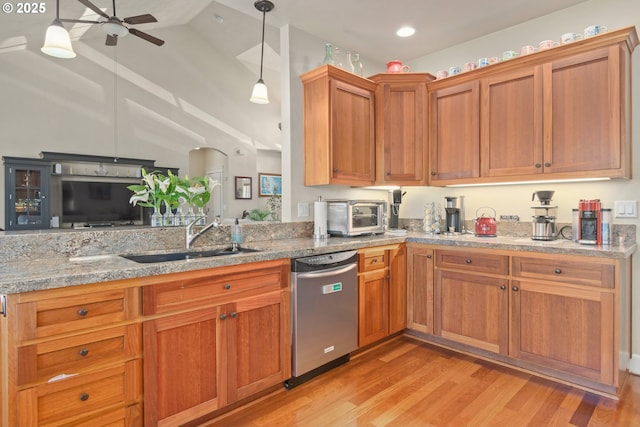 2610 Crowther Dr, Eugene, OR 97404 - kitchen featuring stainless steel dishwasher, a sink, light wood-style floors, a ceiling fan, and light stone counters