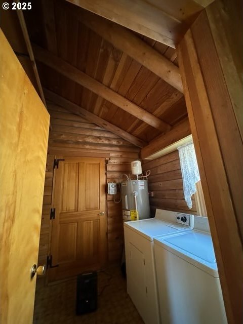 laundry area with rustic walls, laundry area, wood ceiling, electric water heater, and separate washer and dryer