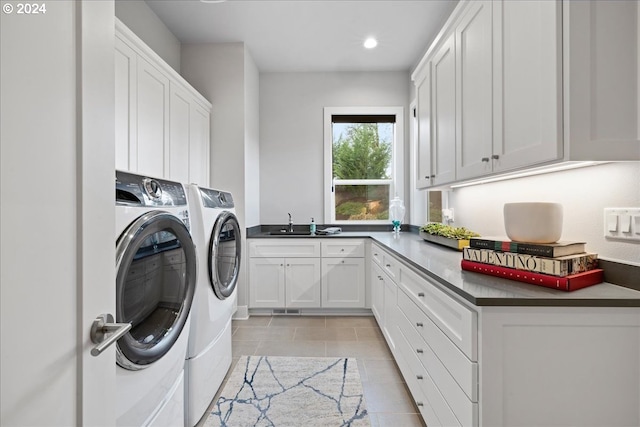 clothes washing area featuring recessed lighting, washer and clothes dryer, a sink, cabinet space, and light tile patterned floors