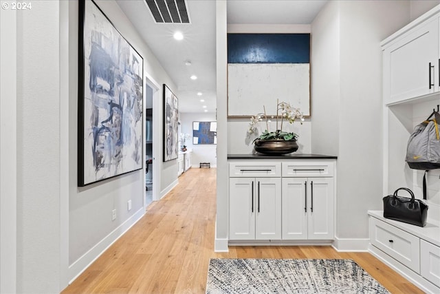 corridor with recessed lighting, baseboards, visible vents, and light wood-style flooring
