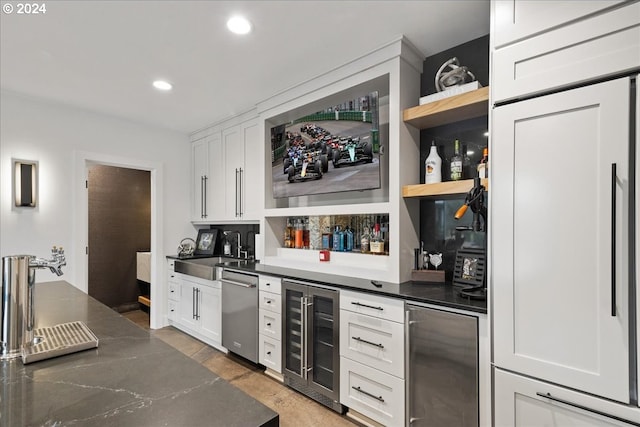 bar with a sink, beverage cooler, indoor wet bar, recessed lighting, and stainless steel appliances