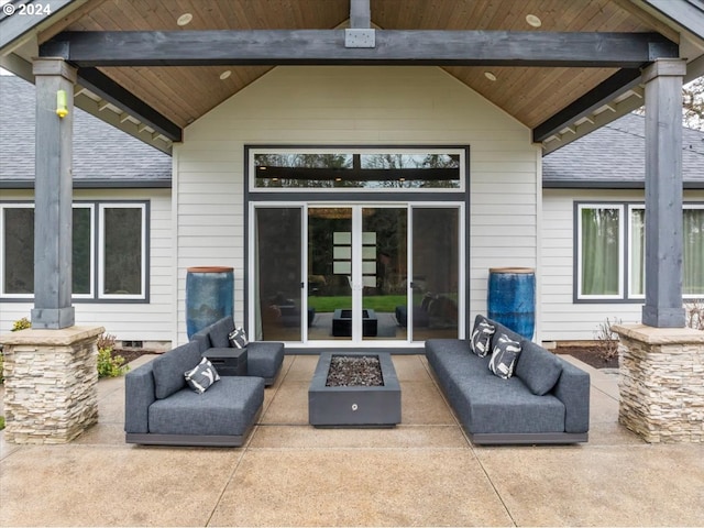 view of patio with an outdoor living space with a fire pit