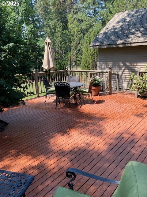 wooden terrace featuring outdoor dining space