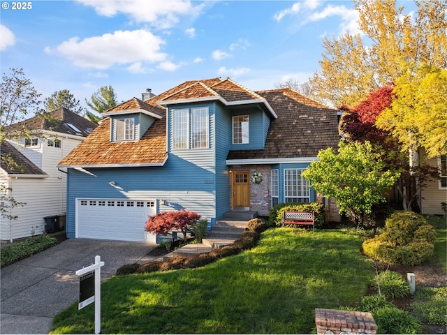 traditional-style house featuring driveway, a chimney, and a front yard