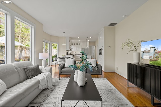 5153 Greensborough Ct, Lake Oswego, OR 97035 - living area with light wood-type flooring, recessed lighting, and baseboards