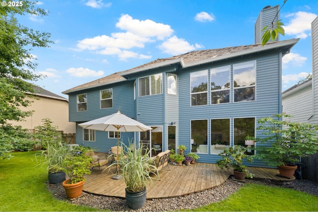 5153 Greensborough Ct, Lake Oswego, OR 97035 - back of property with a deck, a lawn, and a chimney
