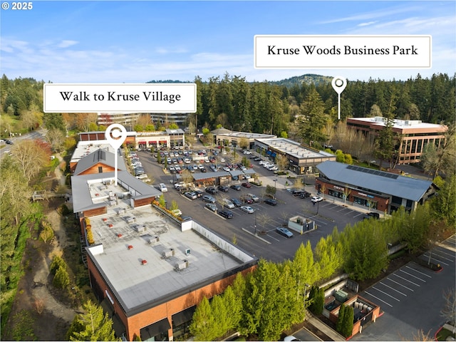 bird's eye view with a wooded view