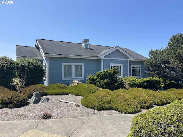 1312 Village Loop, Bandon, OR 97411 - view of front of house featuring a chimney