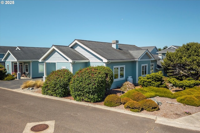 1312 Village Loop, Bandon, OR 97411 - view of front of property with a garage and a chimney