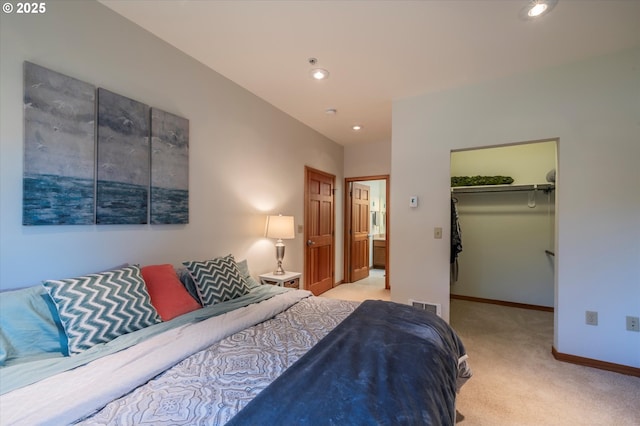 1312 Village Loop, Bandon, OR 97411 - bedroom featuring light colored carpet, recessed lighting, a walk in closet, and a closet