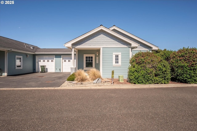 1312 Village Loop, Bandon, OR 97411 - view of front facade featuring asphalt driveway and a garage