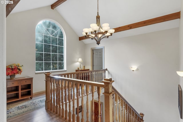 corridor featuring vaulted ceiling with beams, hardwood / wood-style flooring, and a notable chandelier