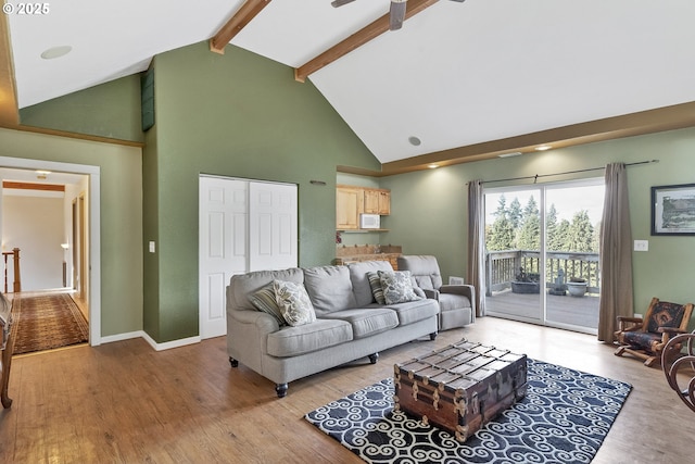 living room with high vaulted ceiling, beam ceiling, and light hardwood / wood-style floors