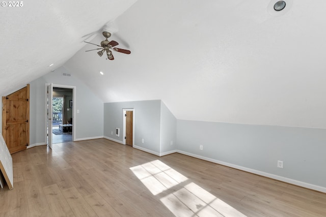 additional living space featuring lofted ceiling, ceiling fan, and light wood-type flooring