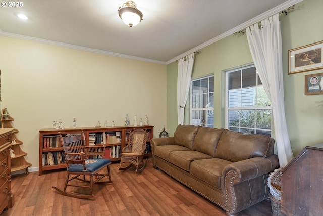 living room with hardwood / wood-style flooring and crown molding