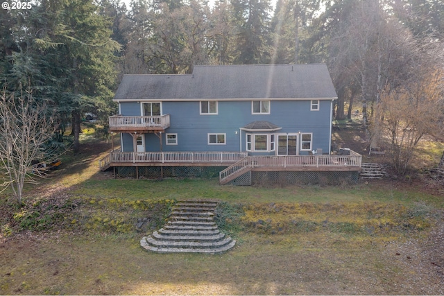 back of house featuring a wooden deck and a yard