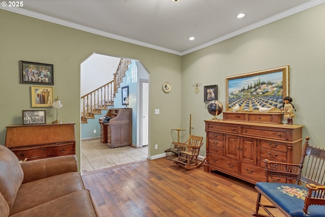 sitting room featuring ornamental molding and light hardwood / wood-style flooring