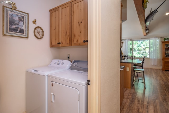 1260 Ireland Rd, Winston, OR 97496 - washroom with wood finished floors, washing machine and clothes dryer, and cabinet space