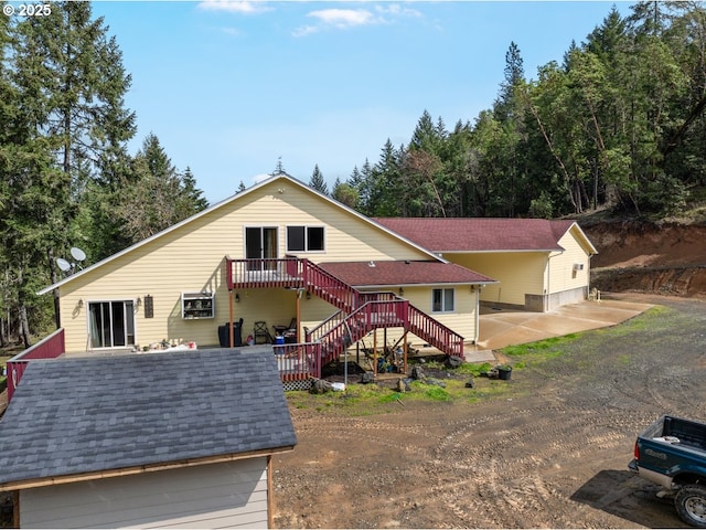 1260 Ireland Rd, Winston, OR 97496 - view of front of home with a shingled roof, a patio area, and stairway
