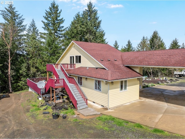 1260 Ireland Rd, Winston, OR 97496 - view of front of property with roof with shingles, concrete driveway, stairway, and a deck