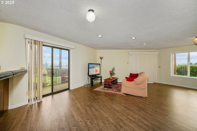 3457 Champlain Ct, Salem, OR 97304 - living area featuring a textured ceiling, baseboards, and wood finished floors