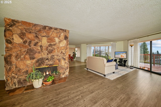 3457 Champlain Ct, Salem, OR 97304 - living room featuring a fireplace, a textured ceiling, a wealth of natural light, and wood finished floors