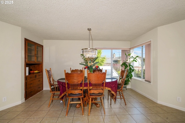 3457 Champlain Ct, Salem, OR 97304 - dining room with an inviting chandelier, a textured ceiling, baseboards, and light tile patterned floors
