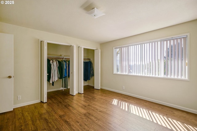 3457 Champlain Ct, Salem, OR 97304 - unfurnished bedroom with two closets, wood finished floors, and baseboards