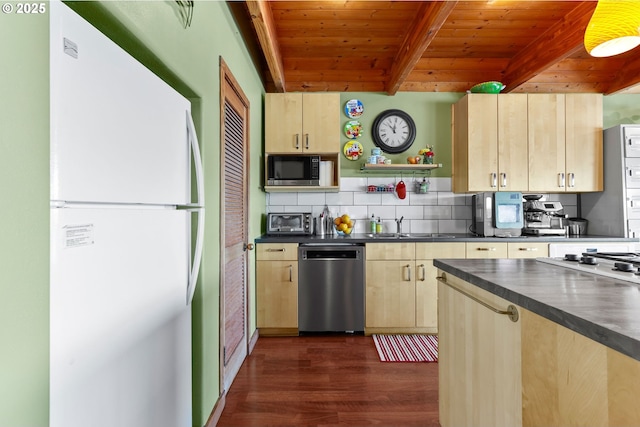 kitchen featuring appliances with stainless steel finishes, light brown cabinets, dark countertops, beamed ceiling, and dark wood finished floors