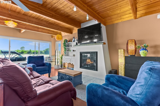 carpeted living room featuring wood ceiling, beamed ceiling, and a fireplace