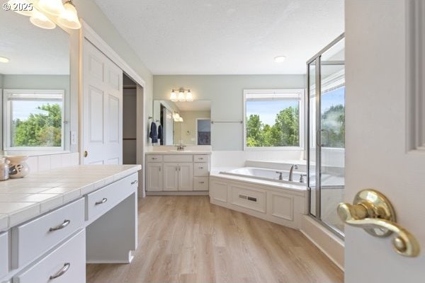 15395 SW Emerald St, Beaverton, OR 97007 - full bath featuring plenty of natural light, two vanities, a garden tub, and wood finished floors