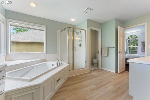 15395 SW Emerald St, Beaverton, OR 97007 - bathroom featuring a garden tub, a stall shower, toilet, wood finished floors, and vanity